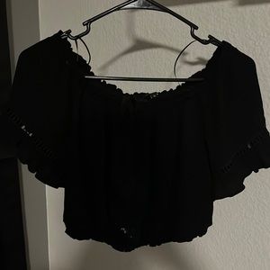 Off the shoulder, black crop top. Lace on the front & sleeves.